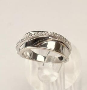 Silver ring with diamond accents on display.