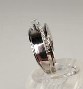 Silver wedding rings with diamond accents displayed.