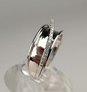 Silver rings with embedded small diamonds.
