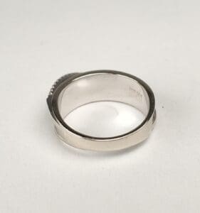 Silver ring with engraved interior details.