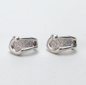 Silver earrings with textured design.