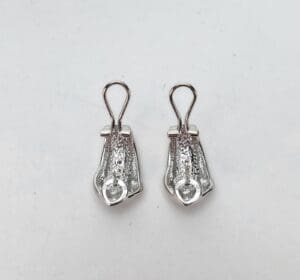 Silver zipper pulls on white background.