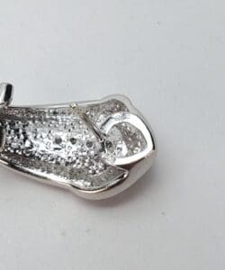Silver metallic clasp on a white background.