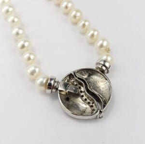 Pearl necklace with silver clasp detail.