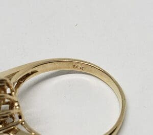 Gold ring with "14K" inscription detail.