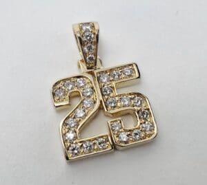 Gold pendant with diamond-studded number 25.