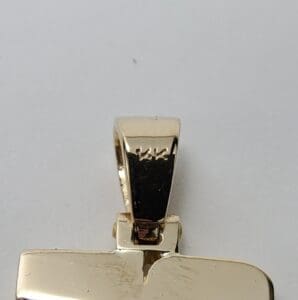 Gold pendant with rectangular shape and bail.