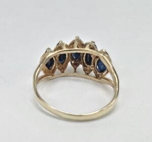 Gold ring with blue gemstone accents.