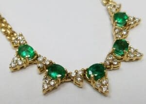 Gold necklace with emeralds and diamonds.
