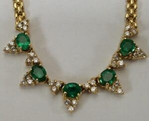 Gold necklace with emeralds and diamonds.