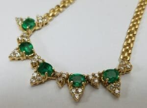 Gold necklace with emeralds and diamonds.