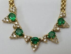 Gold necklace with emeralds and diamonds.