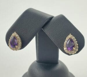Purple teardrop earrings with diamond accents.