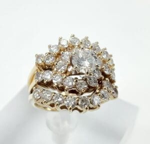 Gold ring with multiple diamond clusters.