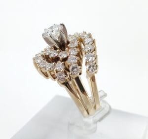 Gold diamond ring with intricate design.