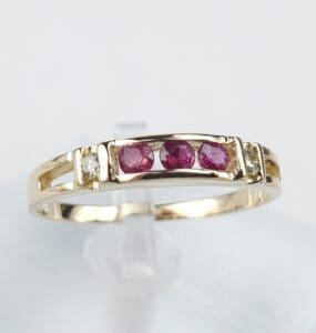 Gold ring with red and white stones.