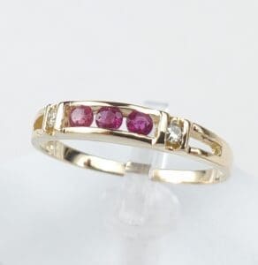 Gold ring with red and clear stones.