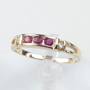 Gold ring with red and clear stones.