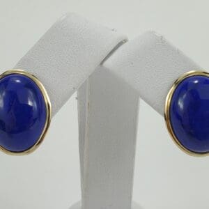 Gold-framed blue stone earrings on display.