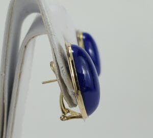 Gold hoop earrings with blue stone.