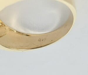 Gold ring with "14K" hallmark inside band.