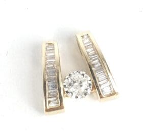 Gold diamond earrings with baguette accents.