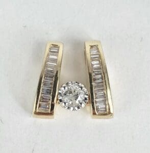 Gold earrings with diamonds on display.