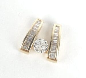 Gold diamond pendant with baguette accents.