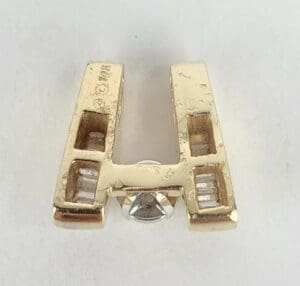 Gold letter "A" pendant with diamonds.
