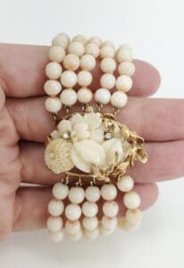 Pearl bracelet with floral clasp design.