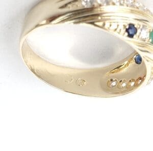 Gold ring with gemstones and engravings.