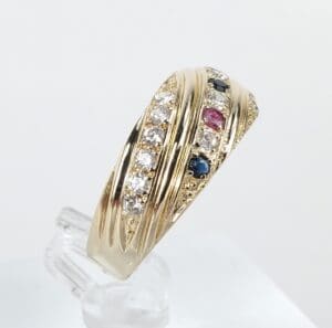 Gold ring with diamonds, red and blue stones.