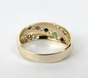 Gold ring with colorful gemstones inside.