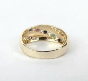 Gold ring with colorful gemstones inside.