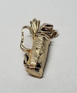 Gold golf bag with clubs brooch.