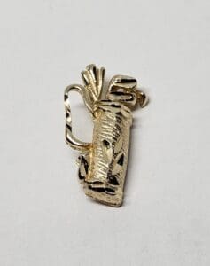 Gold golf bag brooch with clubs.
