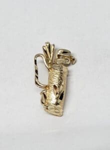 Gold golf bag brooch with clubs.