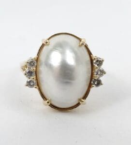 Oval pearl ring with diamond accents.