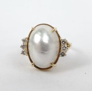 Gold ring with large pearl and diamonds.