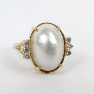 Gold ring with large pearl centerpiece.
