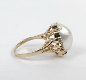 Gold ring with large pearl setting.
