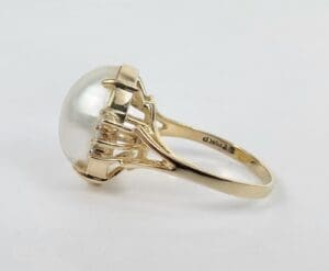 Gold ring with large pearl setting.