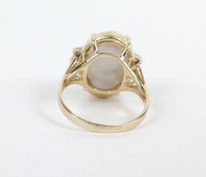 Gold ring with oval stone setting.