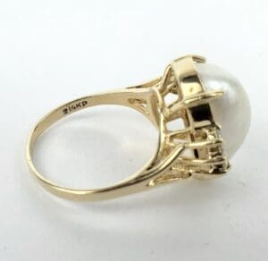 Gold ring with large pearl setting.