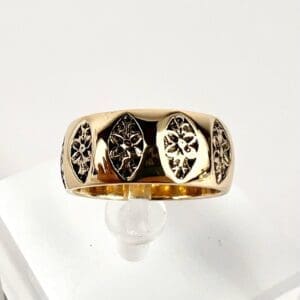 Gold ring with engraved floral patterns.