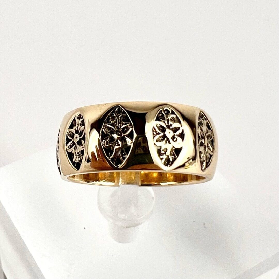 Gold ring with engraved floral patterns.