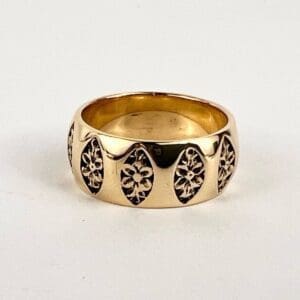 Gold ring with intricate floral pattern.