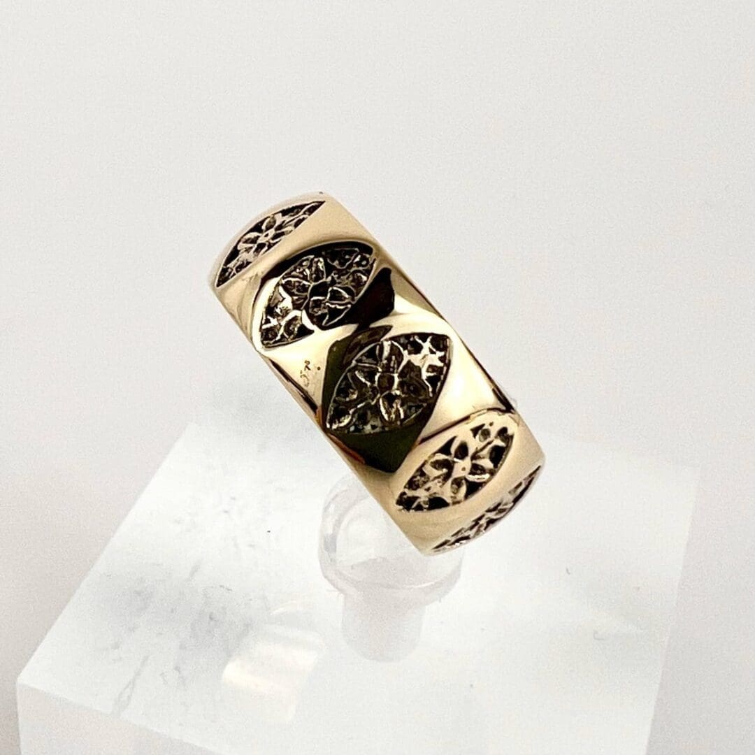 Gold ring with intricate leaf patterns.