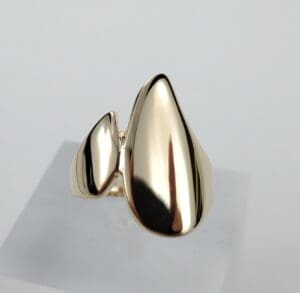 Gold abstract design ring on display.