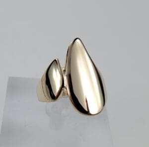 Gold abstract modern design ring on display.